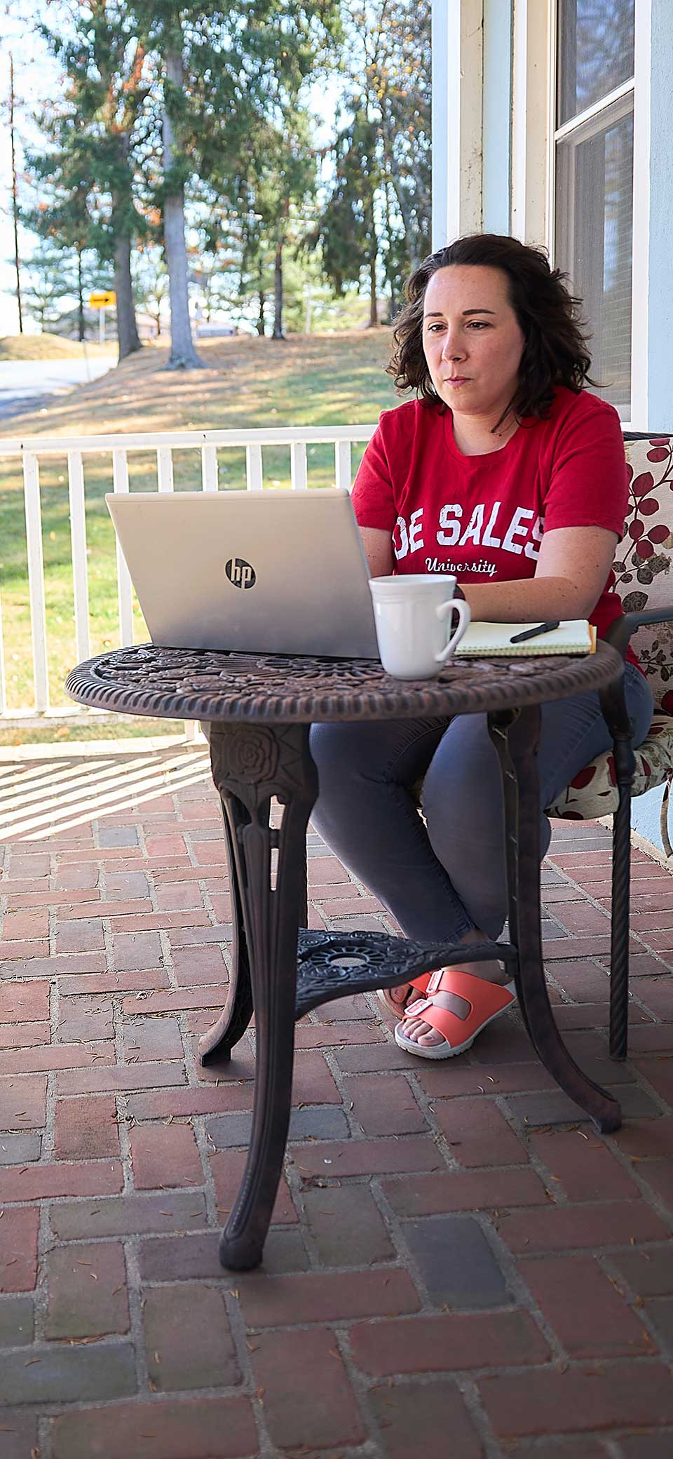 woman on porch with laptop