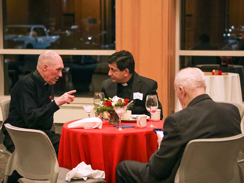father shaju with members of the community