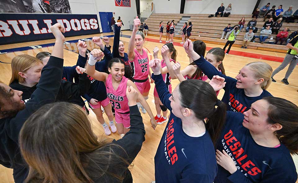 women's basketball team in a huddle