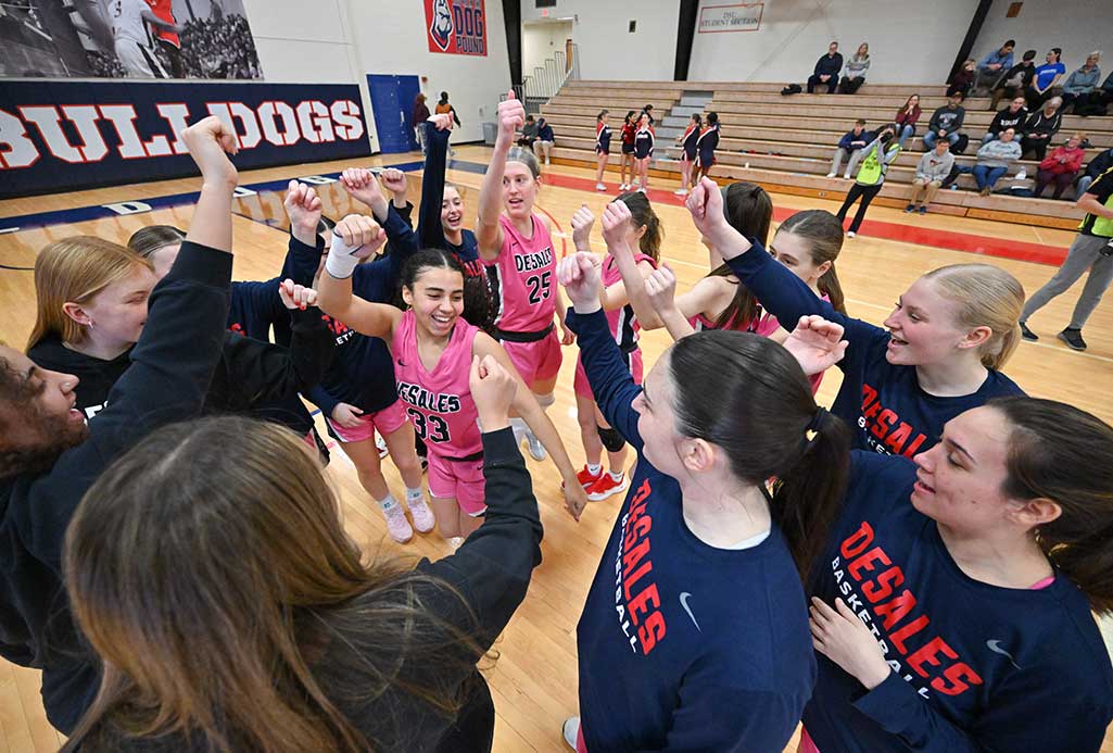 women's basketball team in a huddle