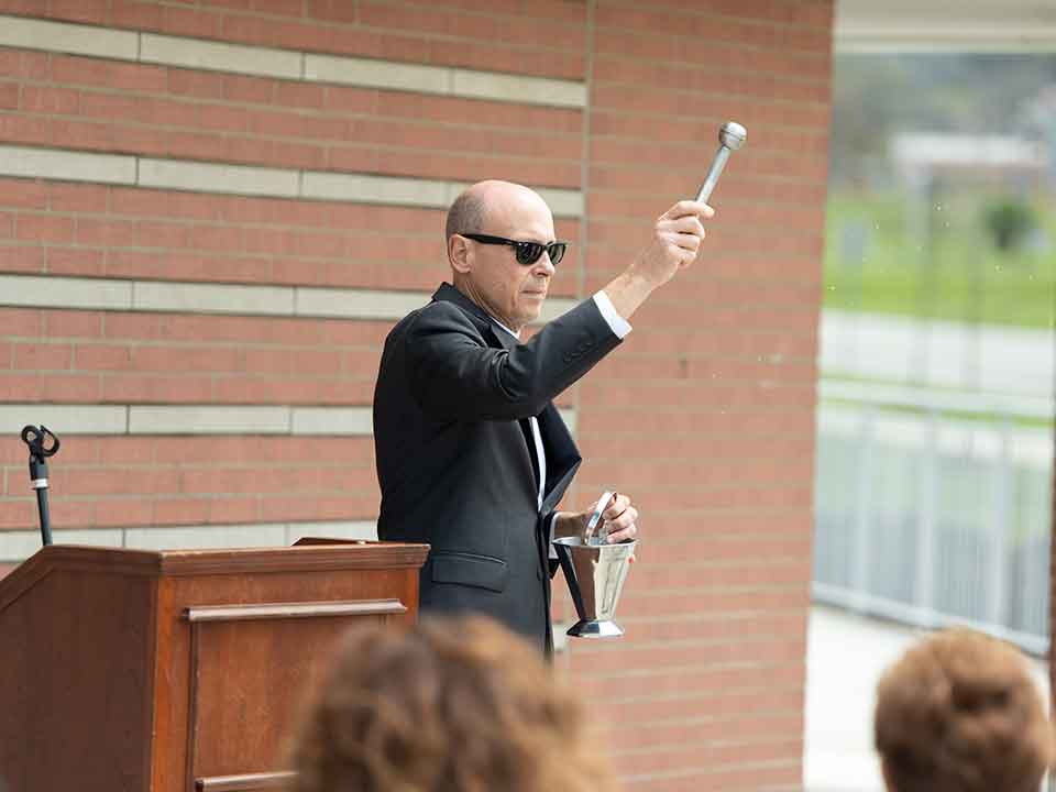 president jim blessing a building