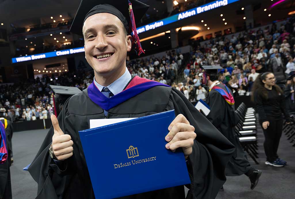 student receiving diploma at commencement