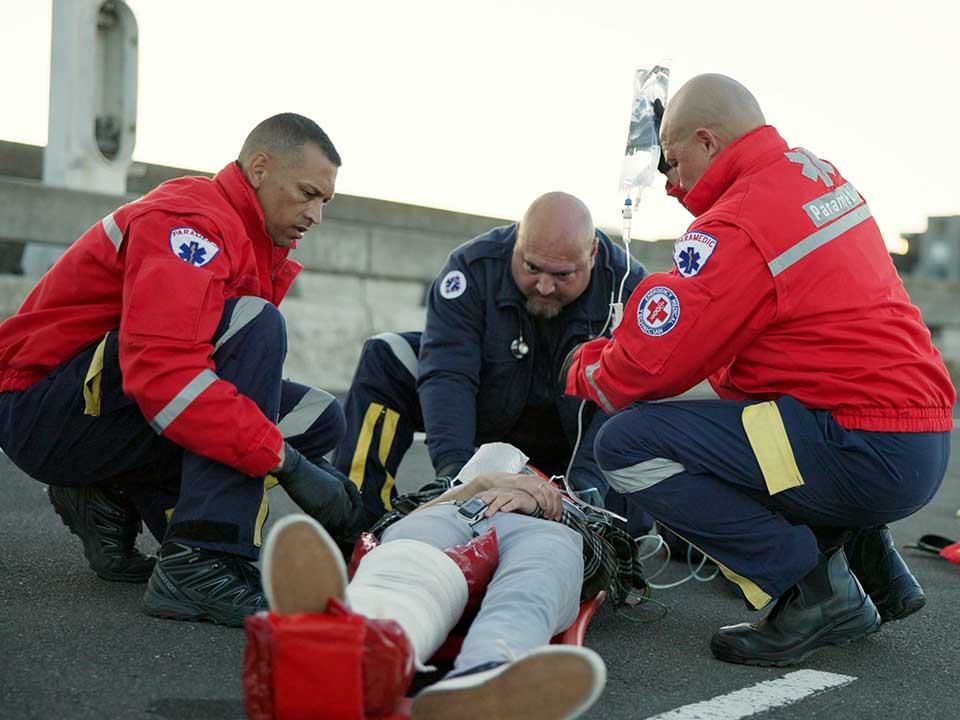 group of paramedics working on a patient
