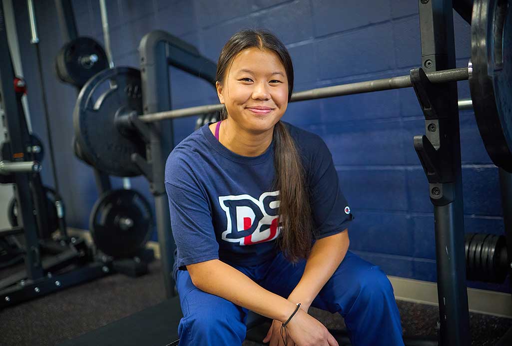 woman using benchpress in fitness center