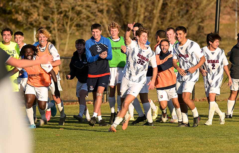 men's soccer team celebrating on the field