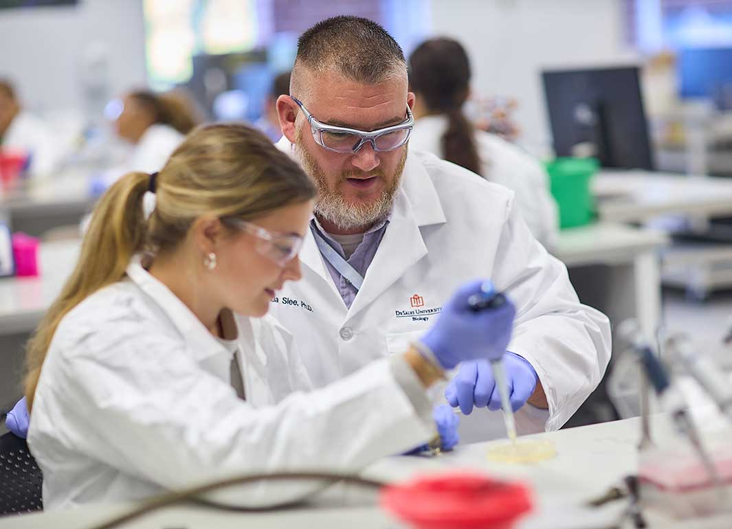 student and professor in biology lab