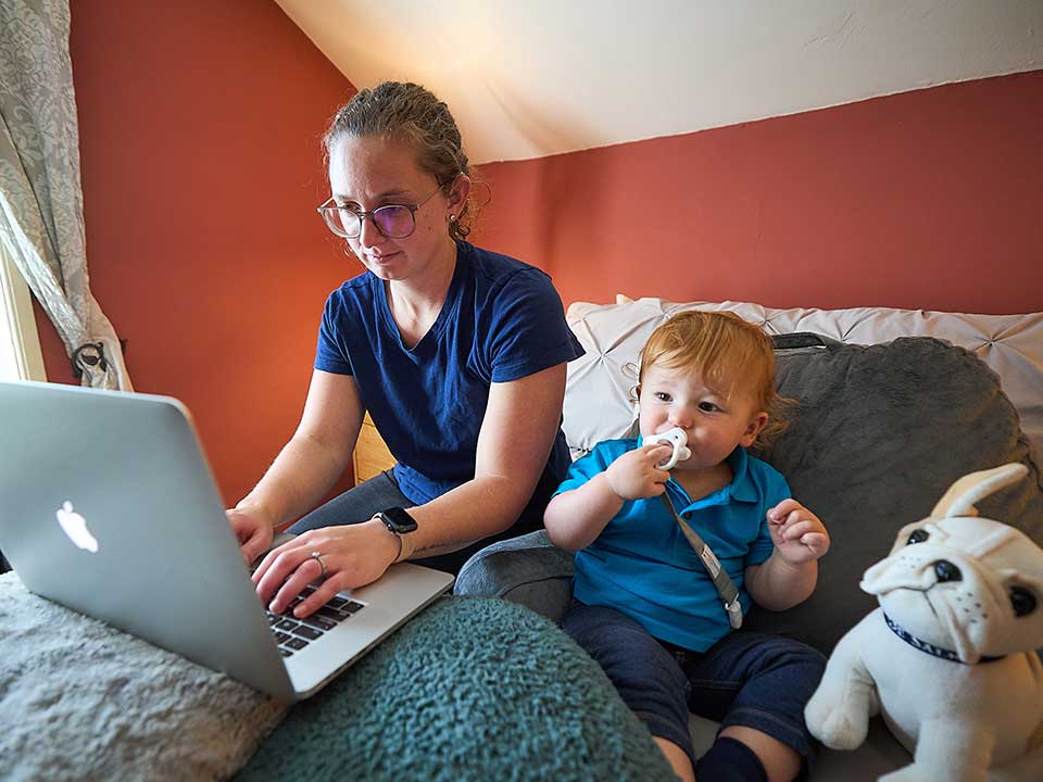 woman on laptop at home with baby