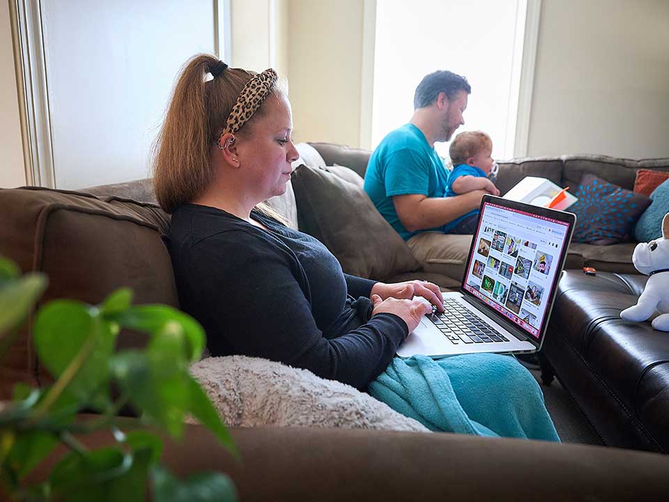 female students using laptop at home