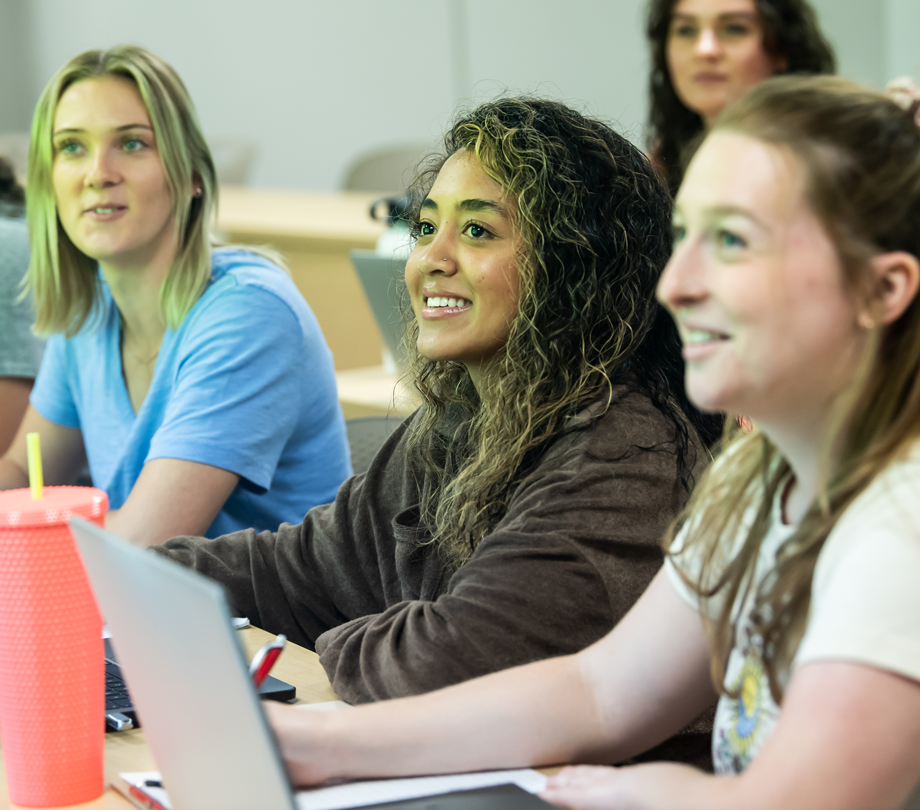 Students smiling at instructor in classroom