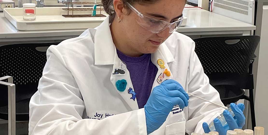 female student performing experiments in science lab